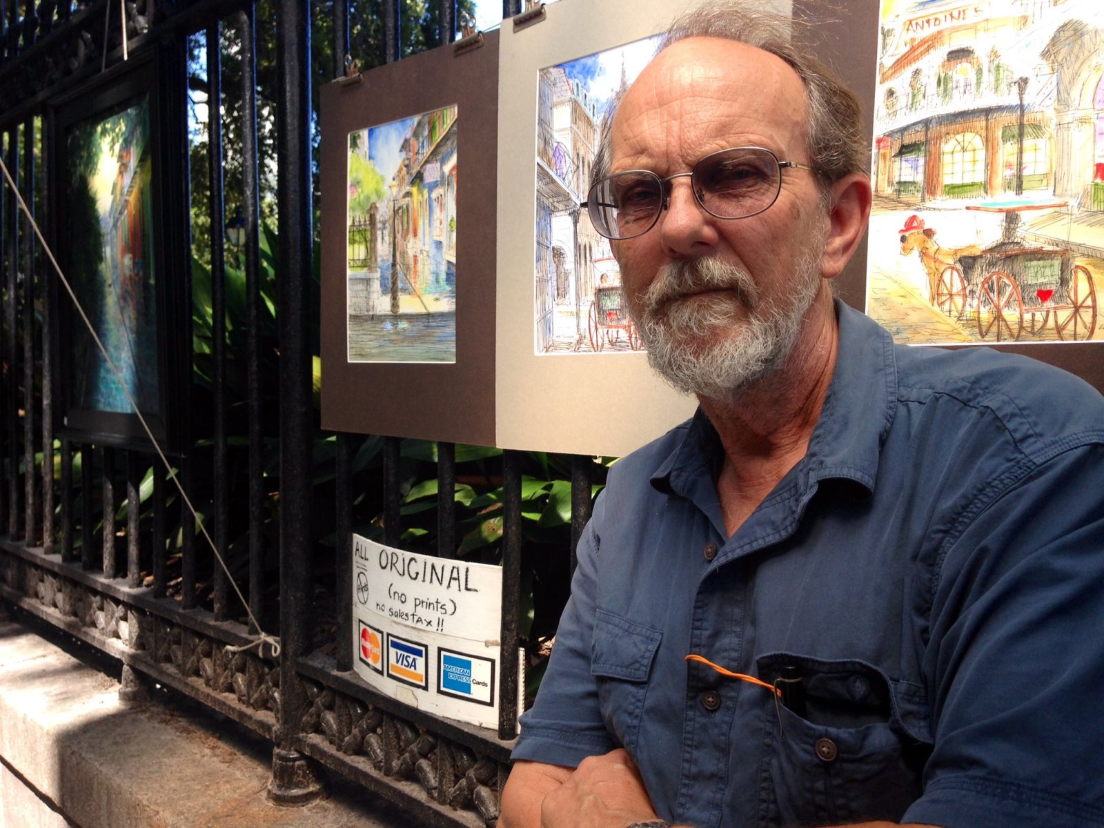 Lee Tucker standing in front of his artwork on Jackson Square